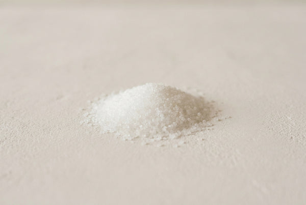 Sodium hydroxide, the white deliquescent solid, weighed dry and dissolved to a dilute solution before it meets a formula.